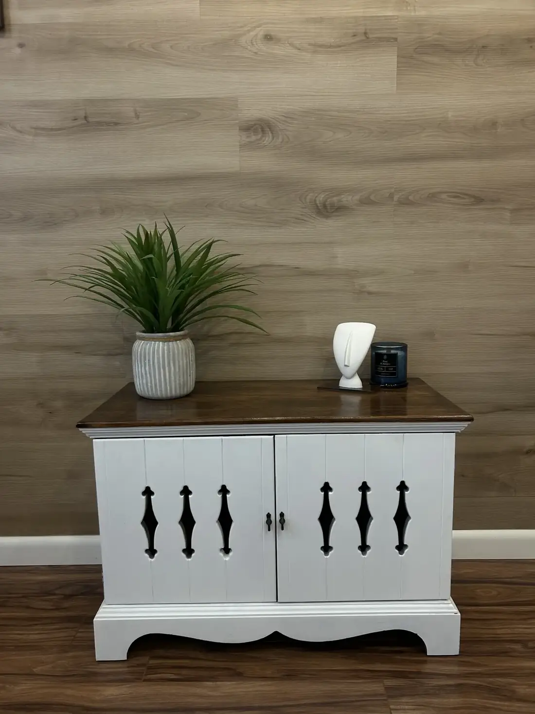 The finished cabinet painted white with a dark walnut top