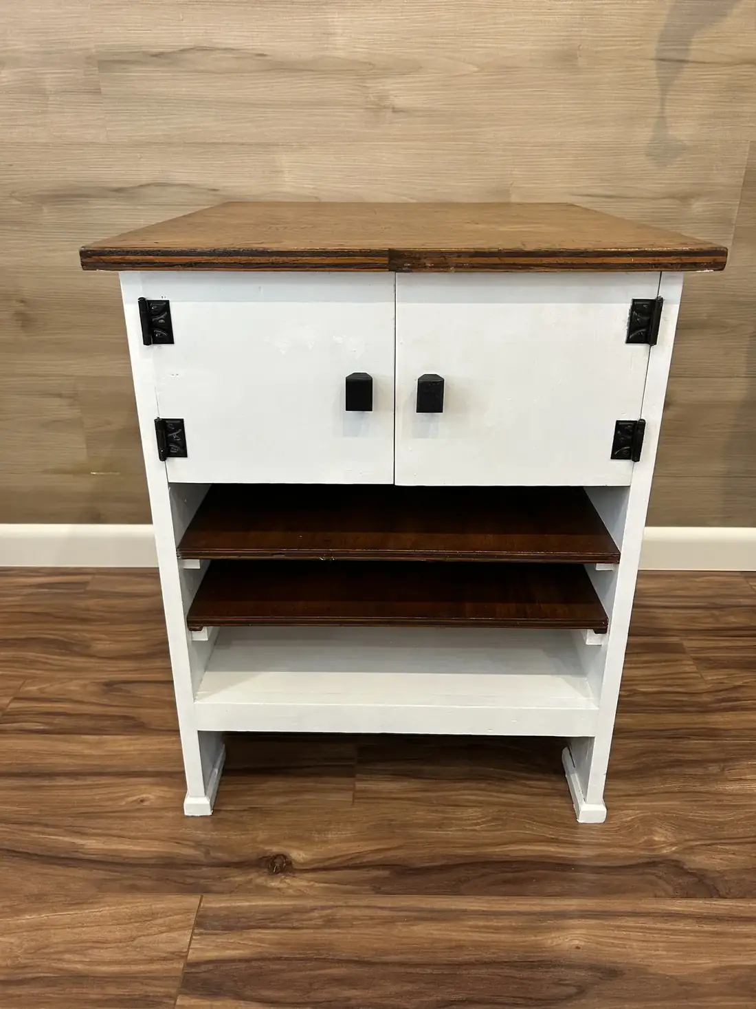 The same cabinet in white with a stained wood top and black hardware